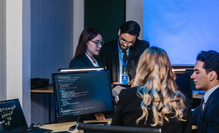 Professionals collaborating in tech environment