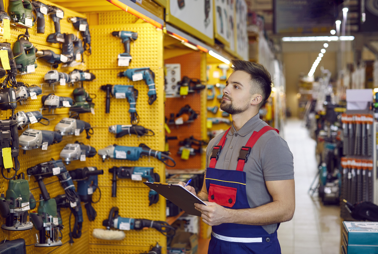 Salesman who works at a DIY store checking construction tools