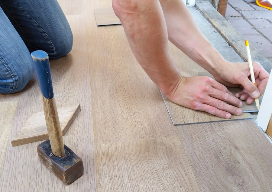 man fixing the floor at home